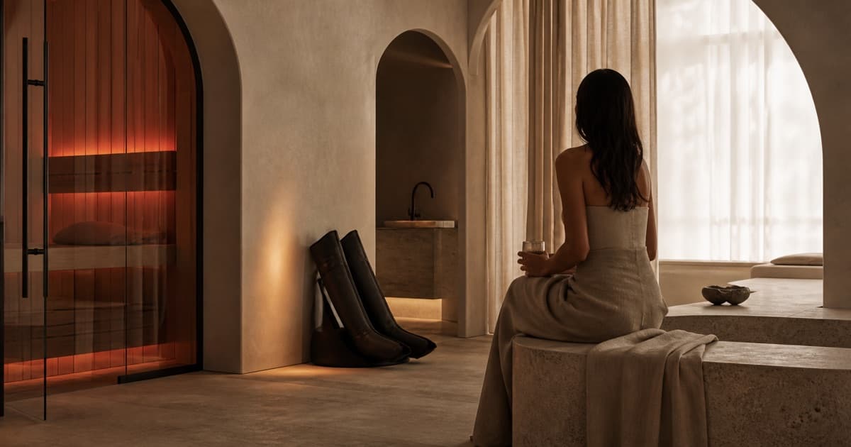 Sculptural private wellness suite in warm neutral light